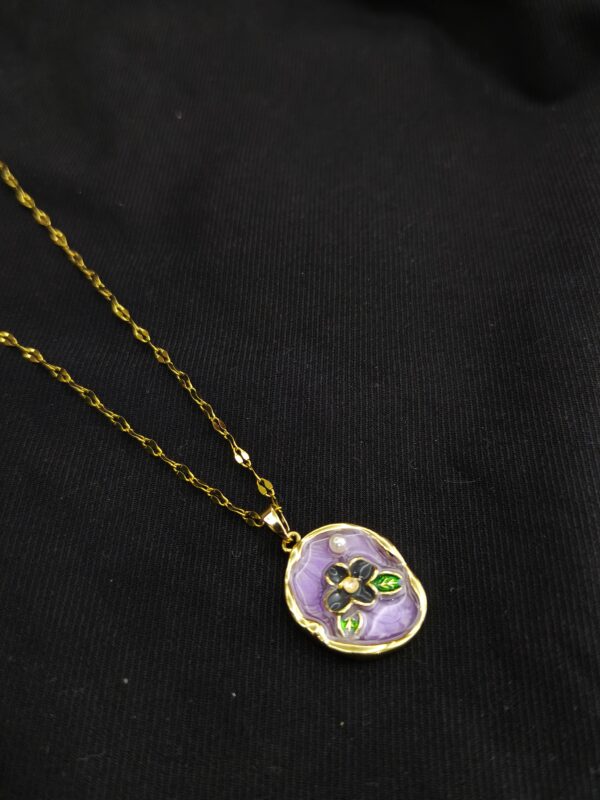 Lavender enamel floral pendant necklace with gold plated chain on black background